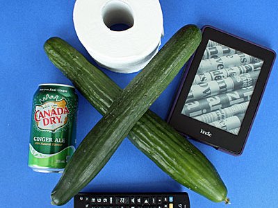 cucumbers,tv remote, kindle,can of ginger ale toilet paper